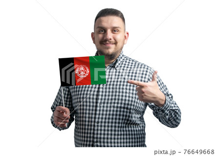 White guy holding a flag of Afghanistan and points the finger of the other hand at the flag isolated on a white background White guy holding a flag of Afghanistan and points the finger of the other hand at the flag isolated on a white background 76649668