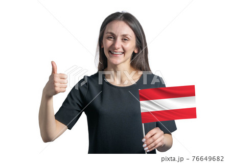 Happy young white woman holding flag of Austria and shows the class by hand isolated on a white background 76649682
