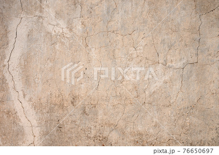 Grunge gray background of cracked peeling walls with peeled putty in beige tones. Grunge gray background of cracked peeling walls with peeled putty in beige tones. 76650697