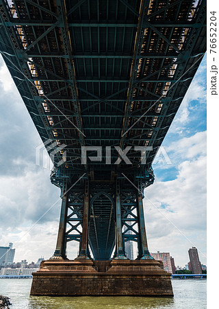 Iconic View Under Manhattan Bridge Against Cityscape of New York City 76652204