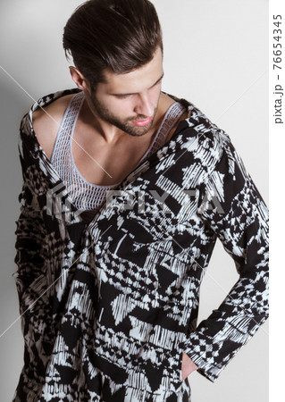 Handsome muscled strong face male model in fashion cloathes on white isolated font background 76654345