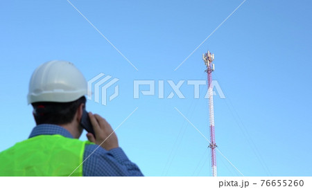 Cellular Engineer next to the Mast. Cell telecommunications 76655260