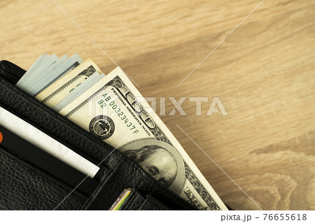 Laptop and wallet with credit card and cash money on a wooden desktop, online payment systems and banking concept. Laptop and wallet with credit card and cash money on a wooden desktop, online payment systems and banking concept. 76655618
