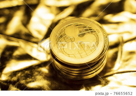 Gold Ripple coins on a golden background. Trading on the cryptocurrency exchange. Cryptocurrency Stock Market Concept. Virtual money concept. Mining or blockchain technology. Business concept. 76655652