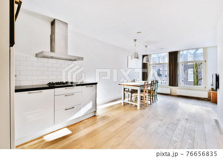 Kitchen and dining zone in modern apartment 76656835