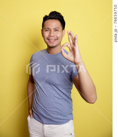 man wearing casual t-shirt smile expression showing OK sign with he hand man wearing casual t-shirt smile expression showing OK sign with he hand 76659750