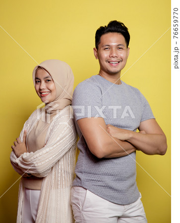 close up hijab women and men smiling crossed arms looking at camera 76659770