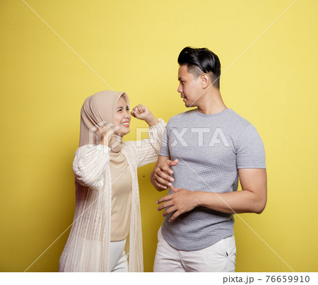 women wearing hijab happy to men smile with very happy expressions looking at each other women wearing hijab happy to men smile with very happy expressions looking at each other 76659910