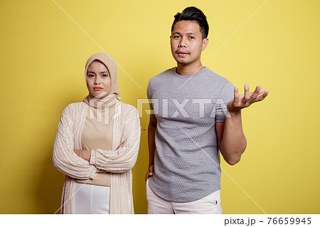 two young people, a woman hijab and a man with an expression asking something 76659945