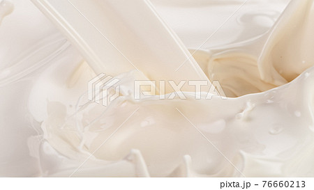 Splashing milk on white background Splashing milk on white background 76660213