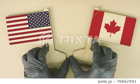 Flags of the USA and Canada made of recycled paper on the cardboard table Flags of the USA and Canada made of recycled paper on the cardboard table 76662091