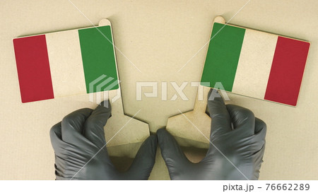Flags of Italy made of recycled paper on the cardboard table 76662289