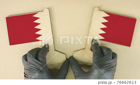 Flags of Bahrain made of recycled paper on the cardboard table 76662613