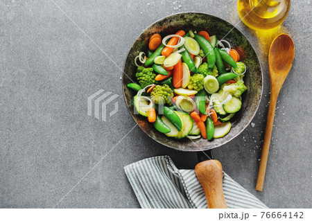 Vegan vegetables on pan on table 76664142