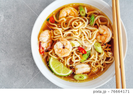 Asian noodles in bowl on concrete background 76664171