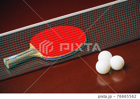 table tennis racket and balls, net background 76665562