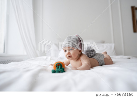 happy baby child in costume a rabbit bunny on a white background 76673160