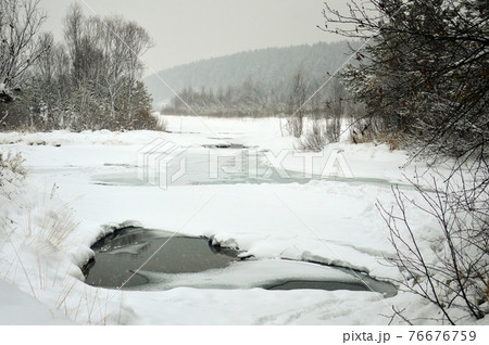 Winter landscape on the river. At the ice-free sagebrush on a cloudy day. An eternal source of pure water. Rivers of Russia, Eastern Siberia Winter landscape on the river. At the ice-free sagebrush on a cloudy day. An eternal source of pure water. Rivers of Russia, Eastern Siberia 76676759