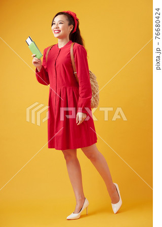 Traveler tourist young beautiful asian woman with backpack, smiling and standing on yellow background. Summer holidays, vacation and travel concept 76680424