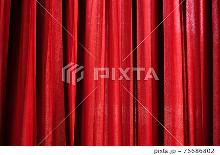 Luxury red closed curtain with light spots in a theater 76686802