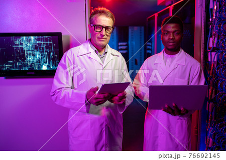 Male server technicians with devices Male server technicians with devices 76692145