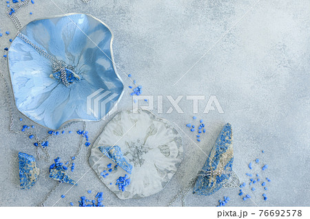Composition with resin art plate and blue stones on gray background. Epoxy resin art. Flat lay Composition with resin art plate and blue stones on gray background. Epoxy resin art. Flat lay 76692578