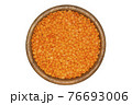 Red lentils in wooden bowl. Isolated on white background 76693006