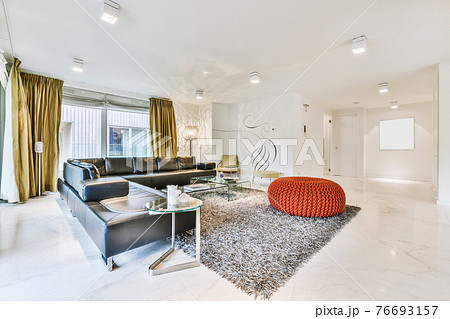 Spacious living room with stylish furniture Spacious living room with stylish furniture 76693157
