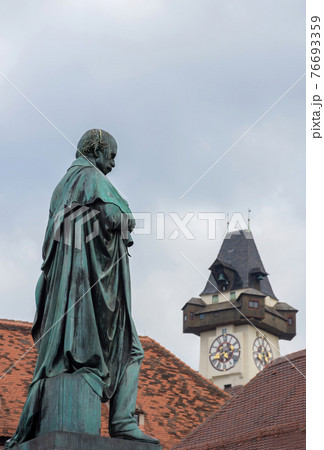 Detail of Erzherzog Johann fountain at Hauptplatz (main square) and the famous clock tower (Grazer Uhrturm) in the background, in Graz, Styria region, Austria. 76693359