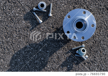 Car inspection. Auto motor mechanic spare or automotive piece on dark road asphalt background. Surface grunge rough of asphalt. Automobile engine service. Car inspection. Auto motor mechanic spare or automotive piece on dark road asphalt background. Surface grunge rough of asphalt. Automobile engine service. 76693790