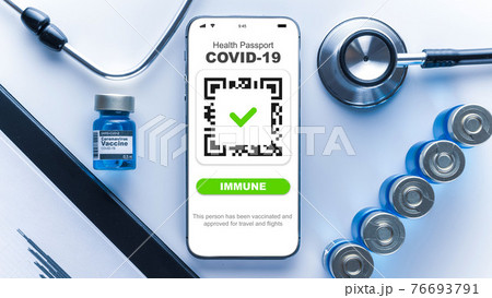 Covid passport. Coronavirus vaccination certificate of immunity passport on smartphone screen with doctor stethoscope, healthcare charts, syringe and medical equipment on hospital white background. Covid passport. Coronavirus vaccination certificate of immunity passport on smartphone screen with doctor stethoscope, healthcare charts, syringe and medical equipment on hospital white background. 76693791