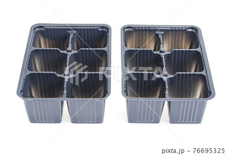 Black plastic cassettes for growing plant seedlings on white background. 76695325