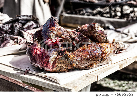 grilled meat a large piece of pork on a fire appetizing on a wooden board 76695958