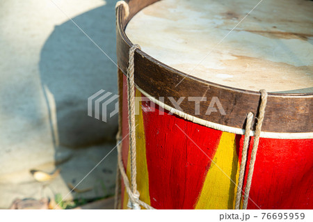 combat drum red yellow close up wooden musical instrument, soft focus 76695959