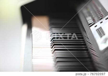 Piano keyboard background with selective focus. Warm color toned image 76702097