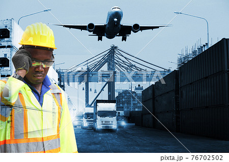 Close up of An African American handsome black engineer he is working in container box yard area,The world logistics  background or transportation Industry or shipping business, Container Cargo  76702502