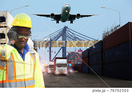 Close up of An African American handsome black engineer he is working in container box yard area,The world logistics  background or transportation Industry or shipping business, Container Cargo  76702503