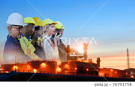team and oil refinery, Teams engineer and foreman working at petrochemical oil refinery in sunset 76703758