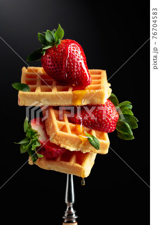 Waffles with strawberries and honey. Waffles with strawberries and honey. 76704583