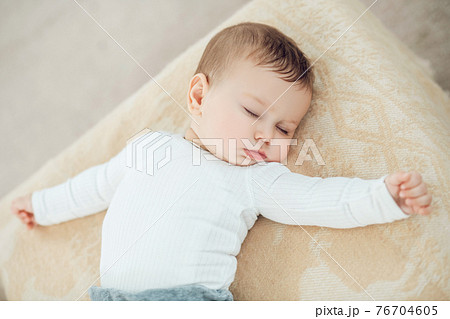 Sleeping cute baby with arms outstretched Sleeping cute baby with arms outstretched 76704605