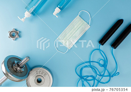 Fitness cleaning gym  Covid 19 virus  alcohol spray anti virus concept Workout from home stay safe 76705354
