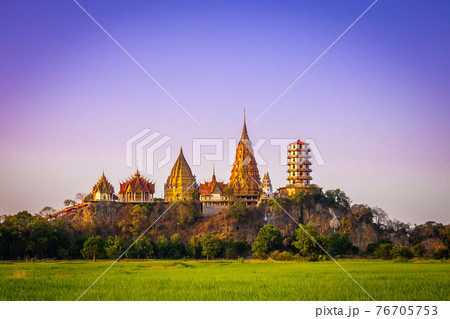 Landscape of Wat Tham Sua at dusk is a very beautiful and popular landmark for tourists in Kanchanaburi, Thailand. 76705753