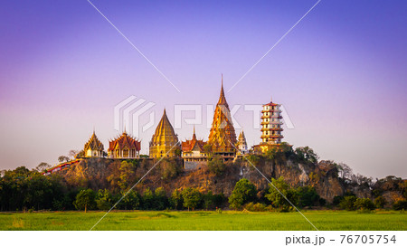 Landscape of Wat Tham Sua at dusk is a very beautiful and popular landmark for tourists in Kanchanaburi, Thailand. Landscape of Wat Tham Sua at dusk is a very beautiful and popular landmark for tourists in Kanchanaburi, Thailand. 76705754