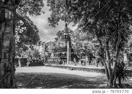 Landmark of old chedi made of ancient bricks in the Kamphaeng Phet Historical Park, Thailand. Black and white Landmark of old chedi made of ancient bricks in the Kamphaeng Phet Historical Park, Thailand. Black and white 76705770