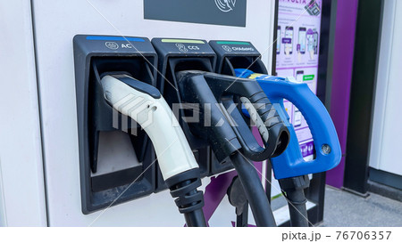 Closeup of Charging station for electric cars. Supporting new technology electric vehicles Closeup of Charging station for electric cars. Supporting new technology electric vehicles 76706357