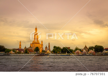 Wat Arun temple at sunset time in on Chao Phraya River Bangkok, Thailand. Important landmarks are symbols 76707301