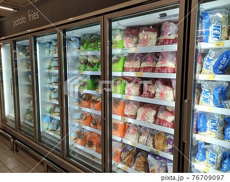 KUALA LUMPUR, MALAYSIA - MARCH 2, 2021: French fries in commercially branded packaging and sold in supermarkets. Place in the chiller to ensure freshness. KUALA LUMPUR, MALAYSIA - MARCH 2, 2021: French fries in commercially branded packaging and sold in supermarkets. Place in the chiller to ensure freshness. 76709097
