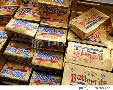 SEREMBAN, MALAYSIA -APRIL 15, 2021: Butter in square packaging is on display on chiller shelves inside the supermarket. Butter is a dairy product made from the fat and protein components of milk. 76709422