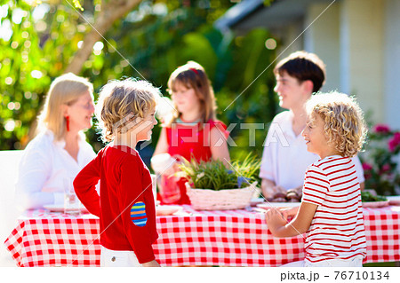 Family eating outdoor. Garden summer fun. 76710134