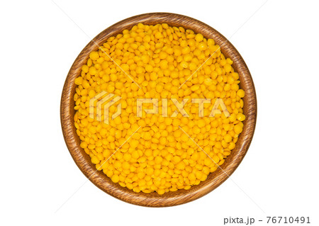 Yellow lentils in wooden bowl. Isolated on white background 76710491
